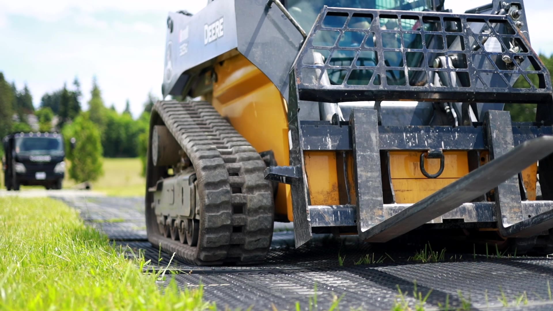 Skid steer crossing ground-protection mats — Toolcart brand film